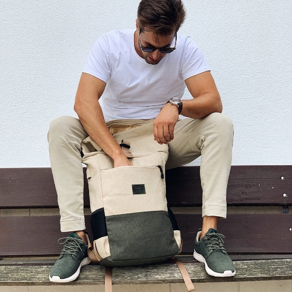 vintage canvas rucksack with quilted laptop sleeve laying on the floor