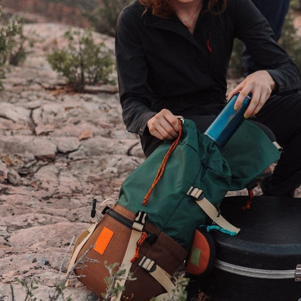 woman looking inside main compartment rover classic pack