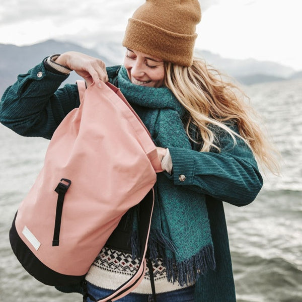 vintage canvas rucksack with quilted laptop sleeve laying on the floor